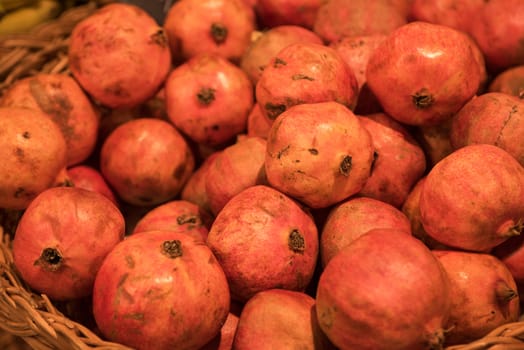 Counter with ripe pomegranates in supermarket 