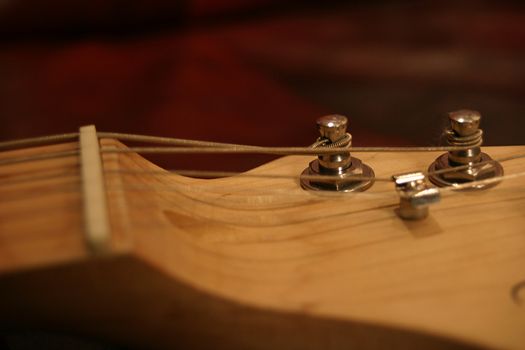Closeup view of a set of electric guitar tuning pegs