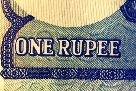 One rupee written in English language on One rupee banknote