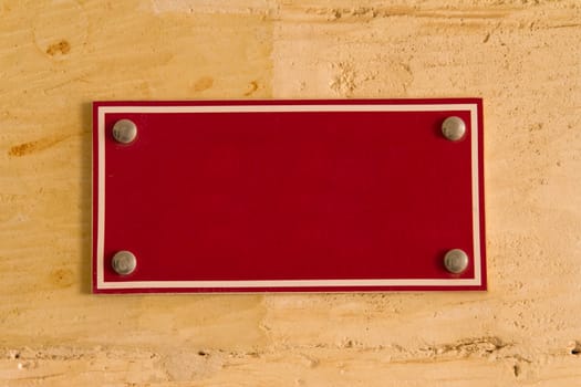 Blank red board sign with space on wall for your designs.