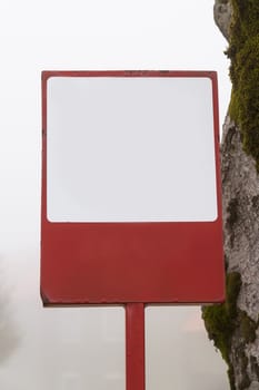 Blank sign board front of tree and foggy background.