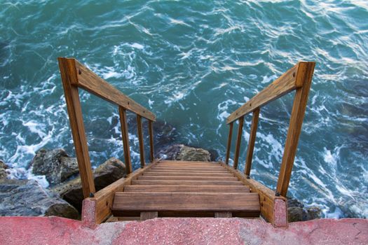 Wavy sea and stairs at the coast.