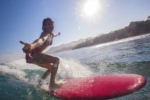 Surfer girl on Amazing Blue Wave, Bali island.