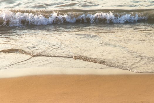 Soft wave of the sea on sandy beach with space.