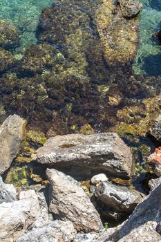 Top view of clear sea with stones and rocks.