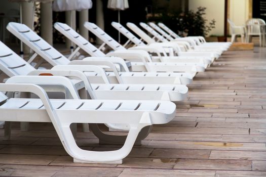 Sunbeds in a row at poolside.