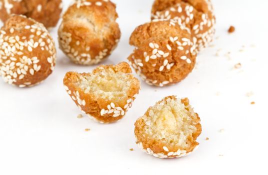cracked crispy donut ball with white sesame on white background