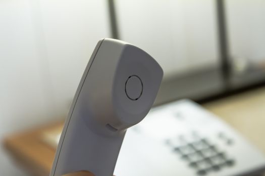 White telephone tube in hotel room.