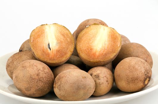 fresh Sapodilla - whole and half cut on white background