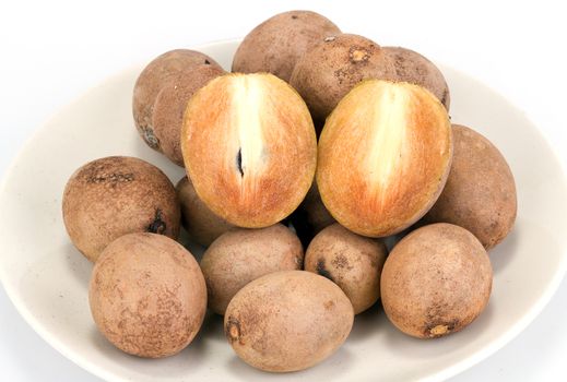 fresh Sapodilla - whole and half cut on white background