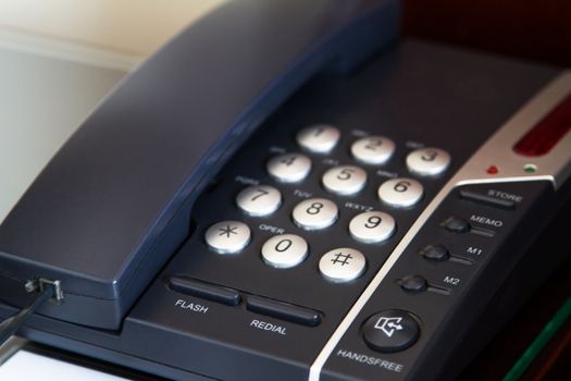 Telephone for customer service in hotel room.