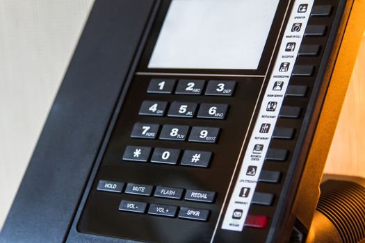 Telephone for customer service in hotel room.