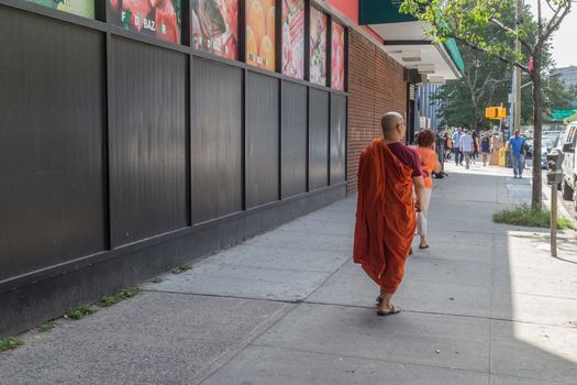 A monk walks on the streets of New York, one of the most culturally diverse cities in the world, Aug 19, 2014, Queens, New York.