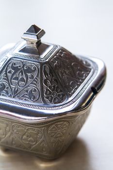Detail of sugar bowl on white background.