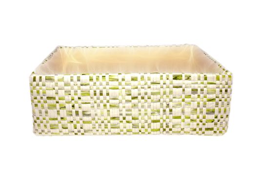 A general view of an empty box with a braided outer surface of warm white and green colors on a white background