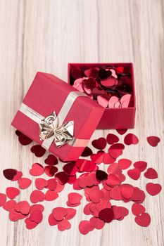 small red hearts confetti and present box full of hearts, valentine love concept