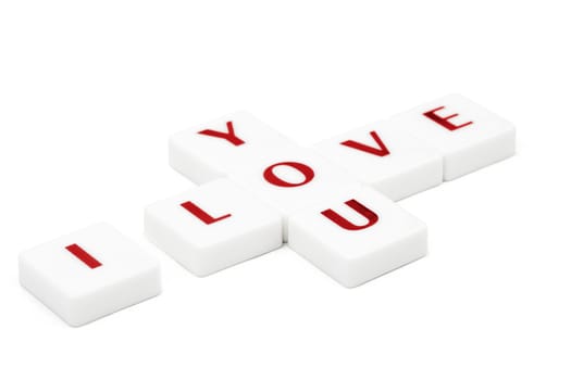 Valentine concept. Scrabble letters spelling I love you isolated on white