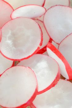 Fresh radishes slices on old wooden table