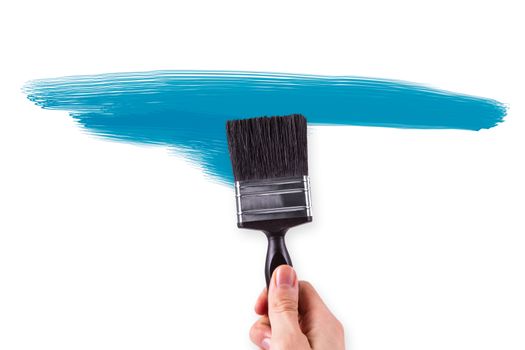Hand painting abstract shapes on white wall.