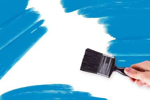Hand painting abstract shapes on white wall.
