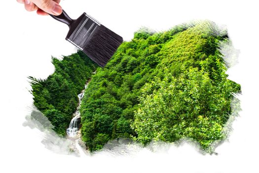Male hand holding paint brush and painting landscape of green forest with trees, isolated on white background.