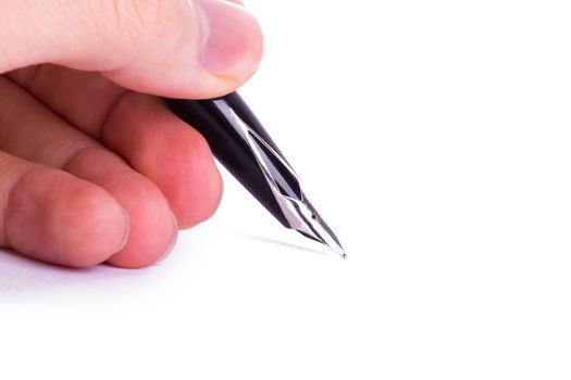 Hand holding black fountain pen, isolated on white background.