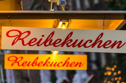 Shield on a Christmas market with the inscription potato pancakes.