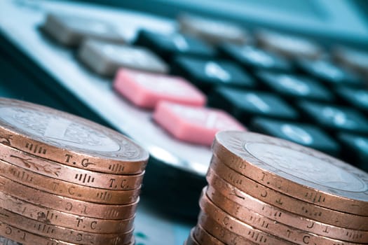 Financial concept, close up view of coins and calculator.