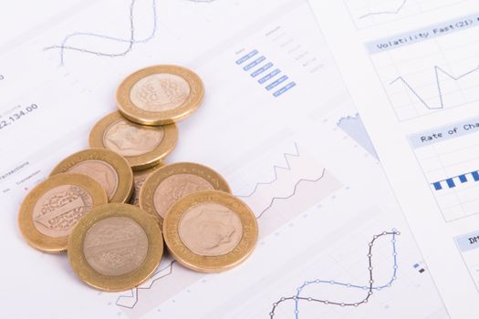 Coins on bar chart graphic results.