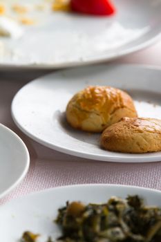 Cookie pieces in  white plate on table.