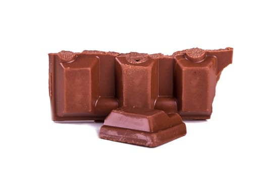 Chocolate bar pieces, isolated on white background.