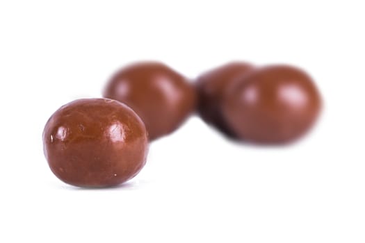 Round milk chocolate candy, isolated on white background.