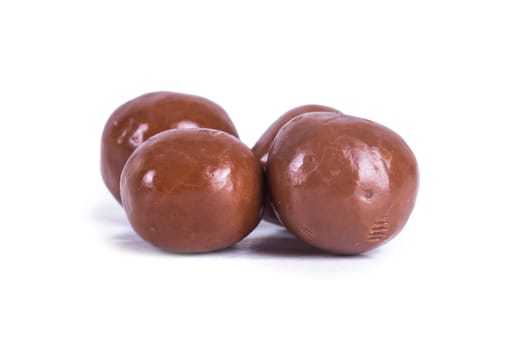 Round milk chocolate candy, isolated on white background.