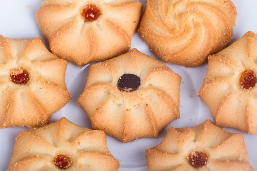 Heap of cookie chips on white.