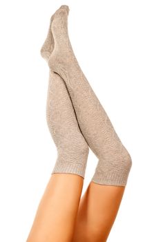 Female legs in knitted socks, white background, isolated