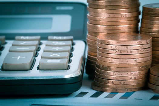 Financial concept, chart graphs, coins and calculator.