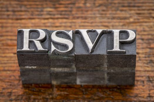 rsvp acronym i(request for a response from the invited person) n mixed vintage metal type printing blocks over grunge wood