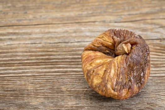 dried Turkish fig on a grained wood background