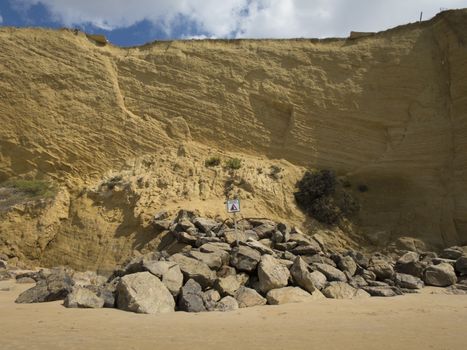 landslides hazard signal spanish advice danger in coastline cliff next to Conil Cadiz Spain Europe