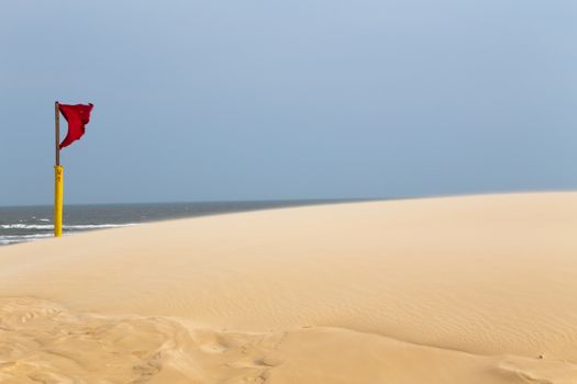 Red flag warning on the beach