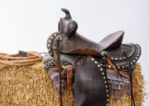 Studio shot of saddle on a hay bale