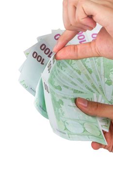 Male hand holding one hundred euro money banknotes, isolated on white background.