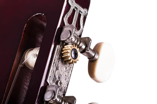 Detail view of fingerboard on classical acoustic guitar, isolated on white background.