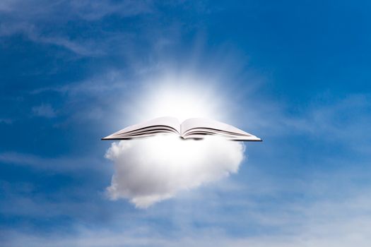 White open blank book in cloud on sky with sunshine.