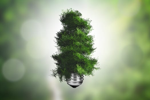 Ecology concept, light bulb with green tree growing on green blurry background.