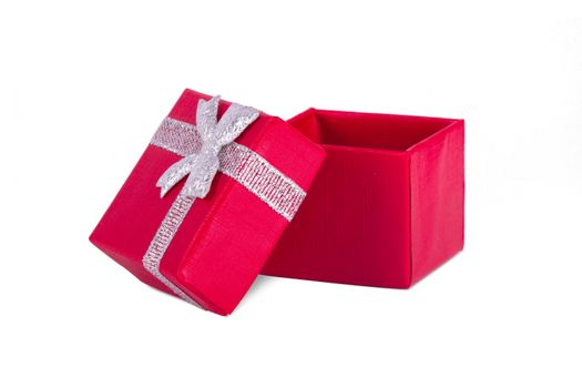 Red little open gift box with ribbon ornament, isolated on white background.