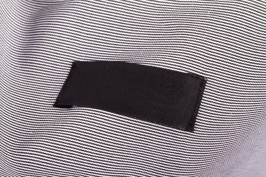 Close up view of blank black label in shirt.