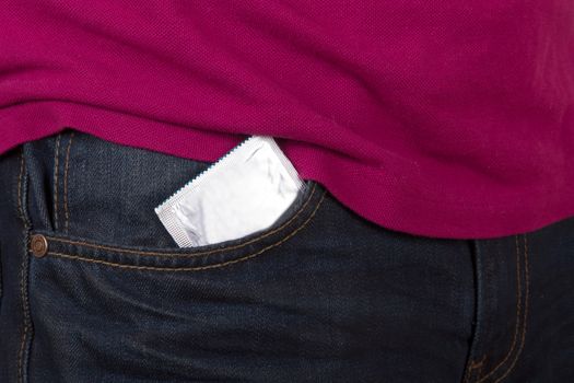 Condom packet in jeans pocket for safe sex.