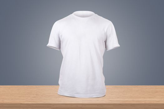 White tshirt template on wooden table for your design, front view on dark background.