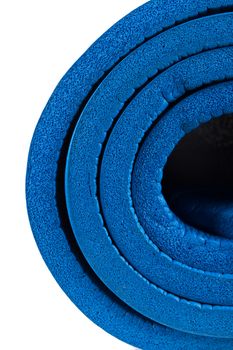 Detail view of blue yoga mat, isolated on white background.